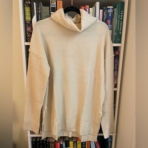 Cream oversized turtleneck sweater with side cut out, size large, tags on